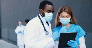 Two doctors reviewing patient files