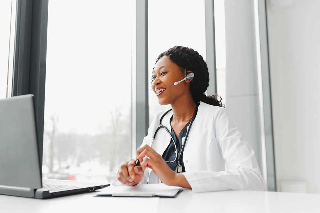 African American woman doctor working at her office online using portable inormation device Telemedicine services Primary care consultations, psychotherapy, emergency services